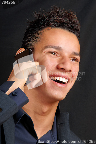 Image of Smiling young business man with mobile