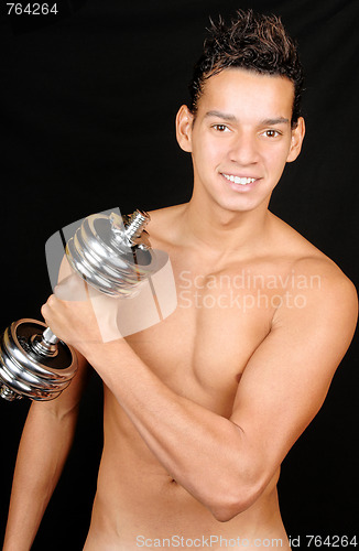 Image of Young man with dumbbell