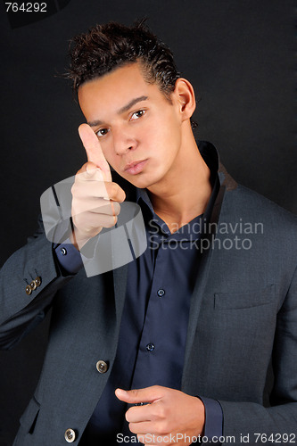Image of Young business man pointing at camera