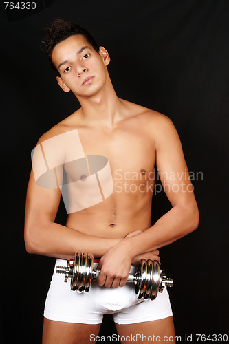 Image of Young man with dumbbell