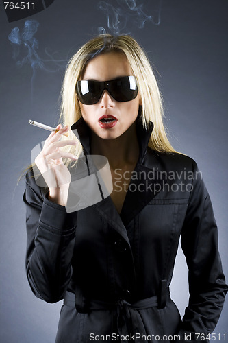 Image of  blond woman holding a cigarette