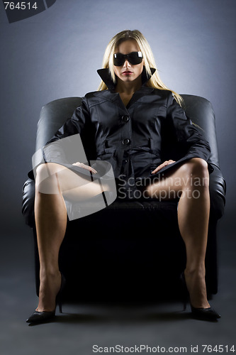 Image of woman sitting on a luxury chair