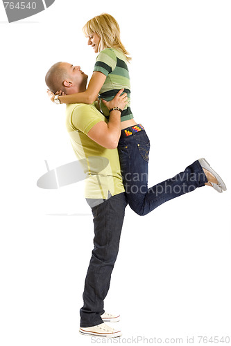 Image of young man holding his girlfriend in the air