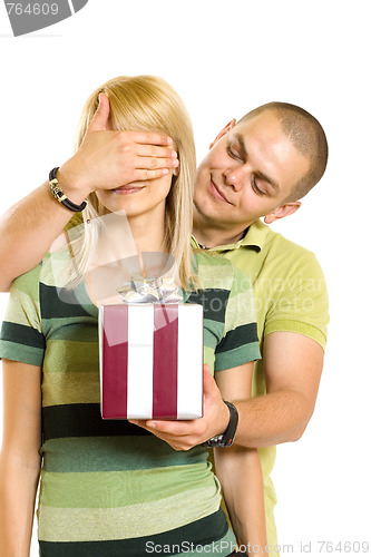 Image of man surprising a woman with present