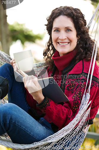 Image of Mature woman reading a book
