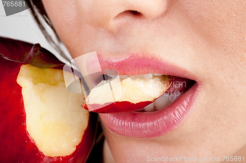 Image of Girl's mouth biting apple