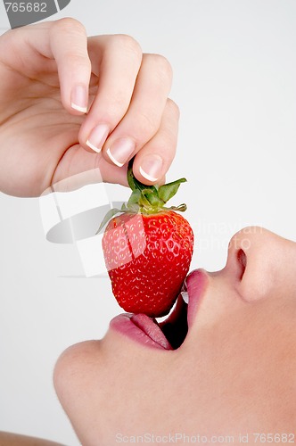 Image of Closeup of girl biting a strawberry