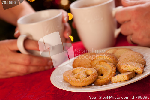 Image of Man and Woman Sharing Hot Chocolate and Cookies