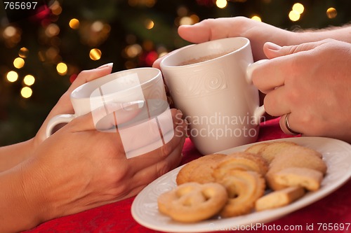 Image of Man and Woman Sharing Hot Chocolate and Cookies