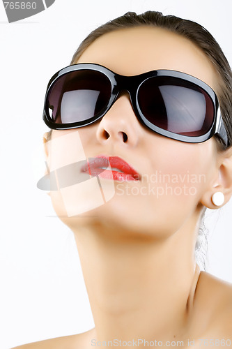 Image of young, beautiful woman wearing sunglasses