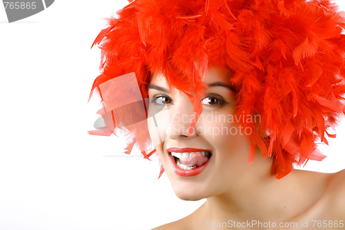 Image of girl in red feathers with tongue ring exposed