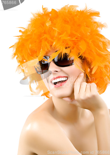 Image of woman wearing an orange feather wig and sunglasses