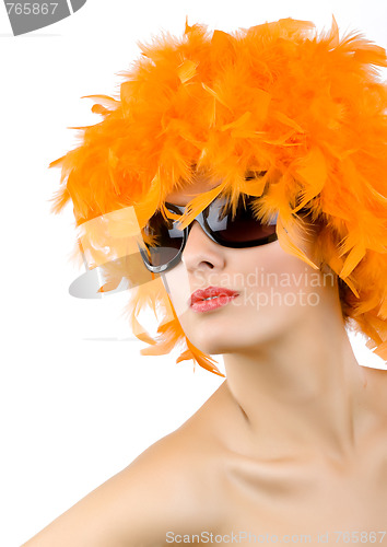 Image of woman with orange feather wig and sunglasses