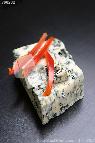 Image of Red pepper slices on cheese