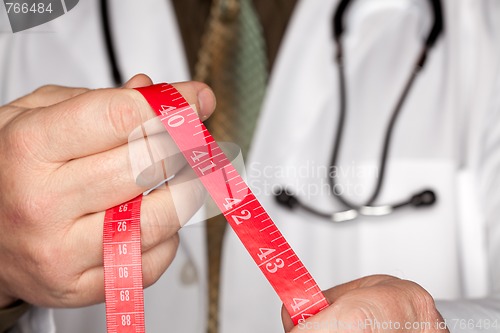 Image of Doctor with Stethoscope Holding Measuring Tape