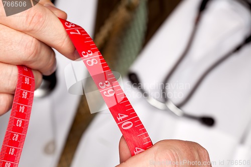 Image of Doctor with Stethoscope Holding Measuring Tape