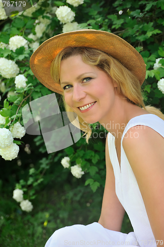 Image of Young woman resting in garden