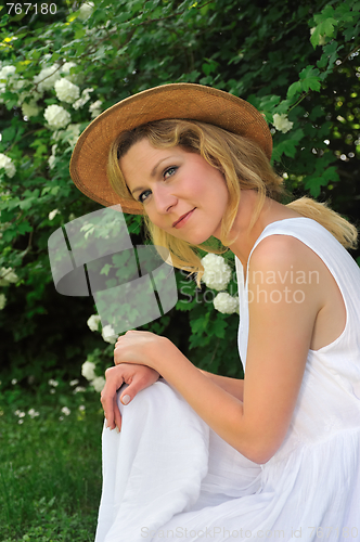 Image of Young woman resting in garden