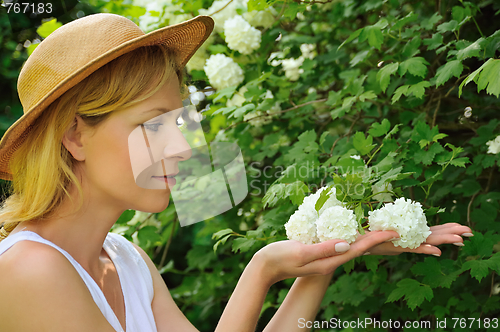 Image of Young woman gardening - taking care of snowball