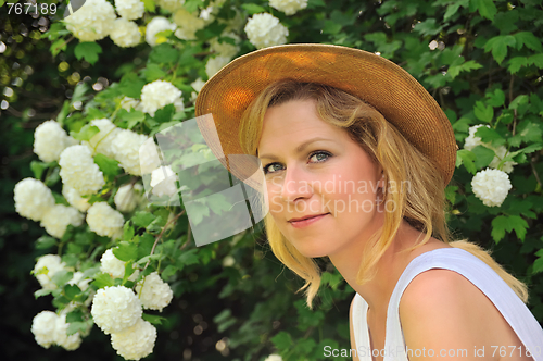 Image of Young woman resting in garden