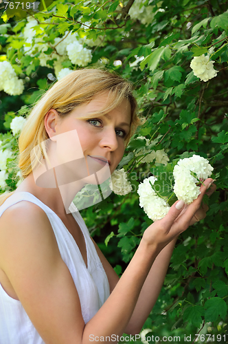 Image of Young woman gardening - taking care of snowball