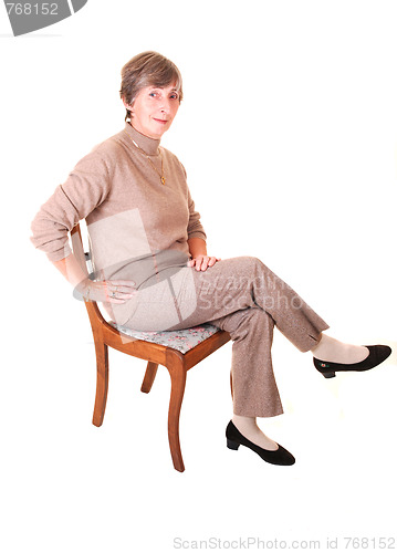 Image of Lady sitting on chair.
