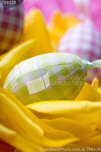 Image of Easter eggs on yellow tulip petals