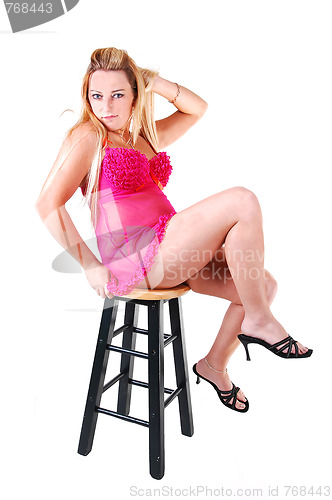 Image of Blond woman in pink lingerie.