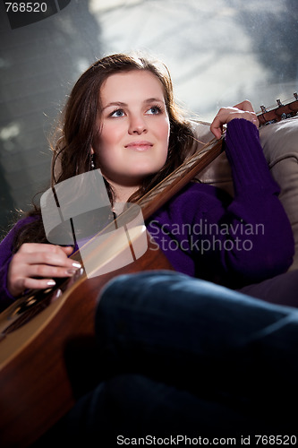 Image of Beautiful teenager playing guitar