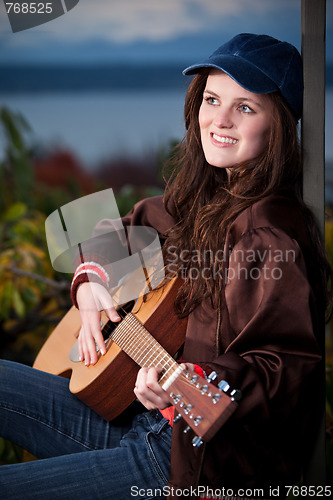 Image of Beautiful teenager playing guitar