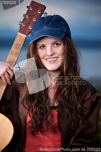 Image of Beautiful teenager playing guitar