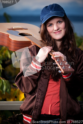 Image of Beautiful teenager playing guitar