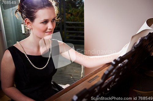 Image of Beautiful teenager playing piano