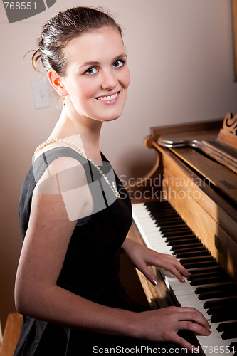 Image of Beautiful teenager playing piano