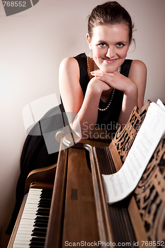 Image of Beautiful teenager playing piano