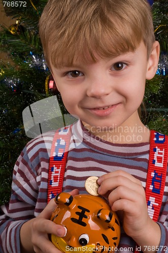 Image of Boy with piggy bank