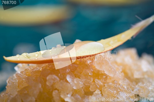 Image of Bath salt with water droplets on flower petal