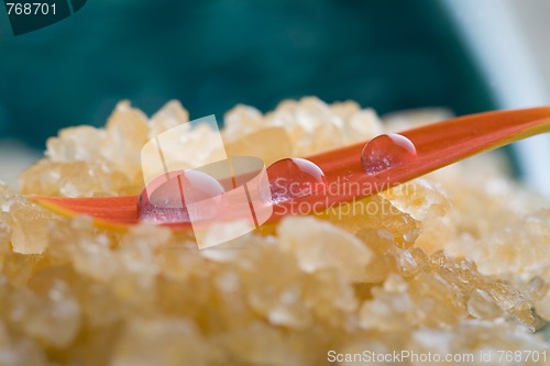 Image of Bath salt with water droplets on flower petal