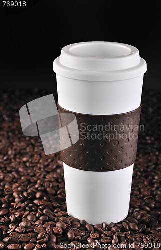 Image of Commuter coffee cup on coffee beans.