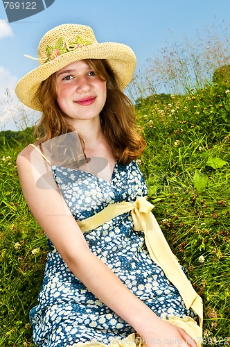 Image of Young girl sitting in meadow