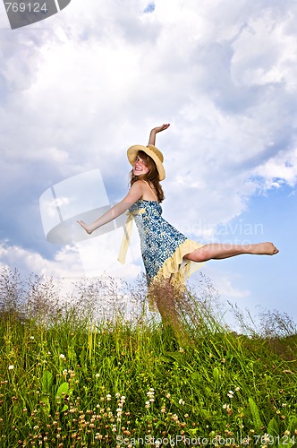 Image of Young girl dancing in meadow