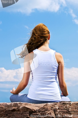 Image of Young girl meditating outdoors