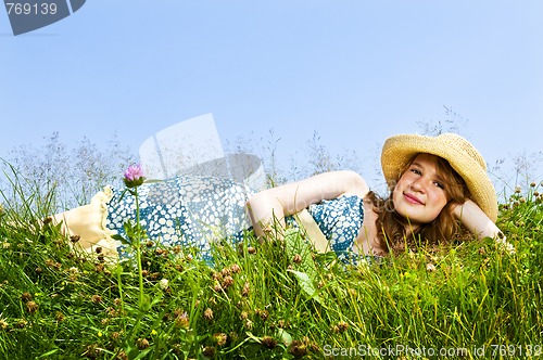 Image of Young girl laying in meadow