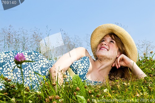 Image of Young girl laying in meadow