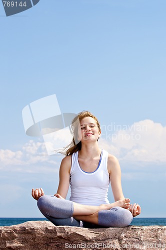 Image of Young girl meditating outdoors