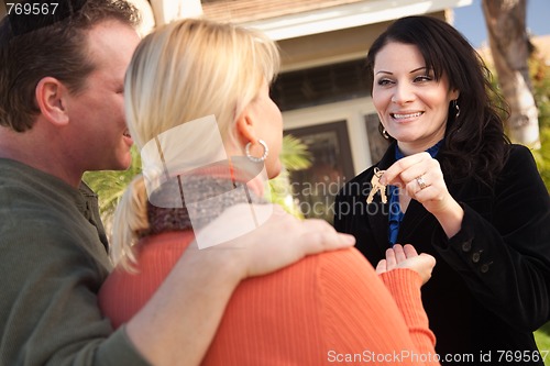 Image of Attractive Hispanic Female Real Estate Agent Handing Over Keys