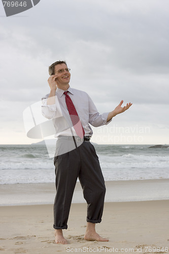 Image of Businessman talking on cell phone 