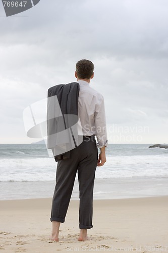 Image of Businessman relaxing on a beach