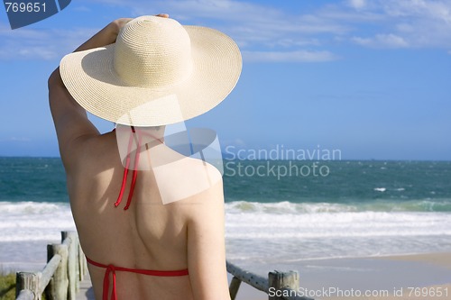 Image of Woman with hat looking at the sea