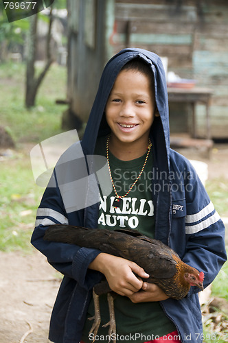 Image of editorial happy boy with pet hen chicken corn island nicaragua